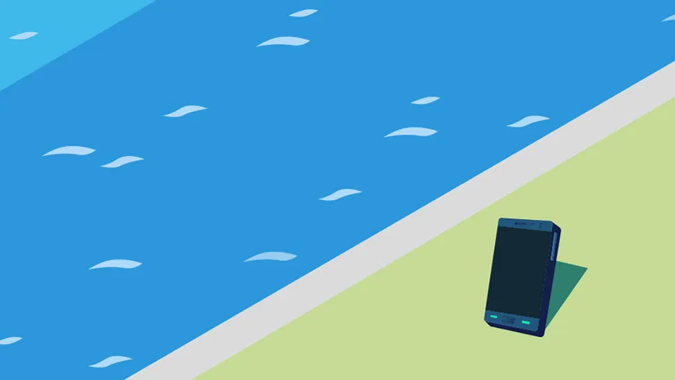 Front view of a smartphone lying face up on green grass beside a blue pool with visible water ripples.
