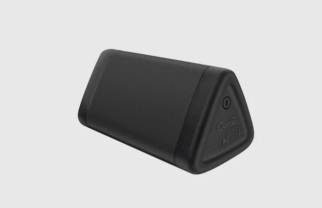Side view of a black, triangular OontZ Bluetooth speaker with control buttons, on a light gray background.