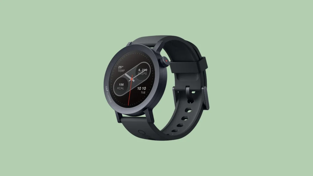 Front view of a black Android smartwatch with round display and silicone strap, showing time, date, steps, and more.