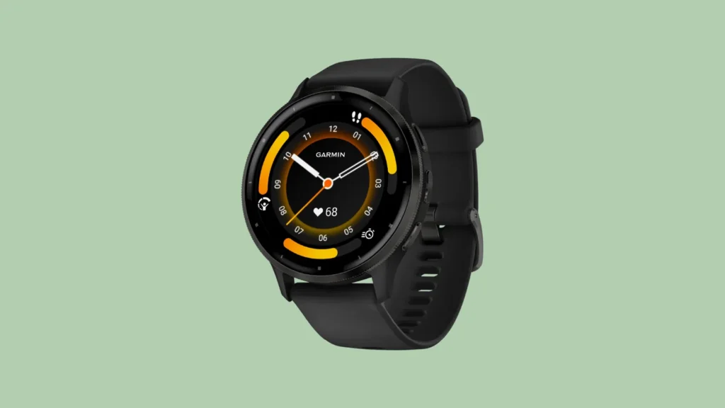 Front view of black Garmin smartwatch with round face showing time, date, heart rate, and activity stats on light green background.