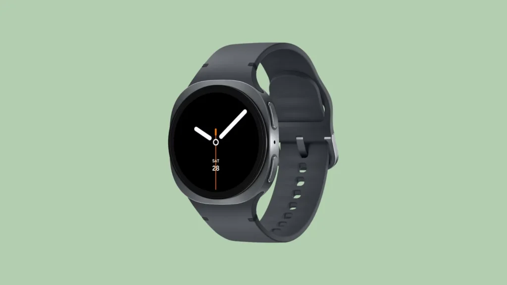 Front view of a black round smartwatch with silicone strap on light green background; screen shows time and date set to 28.