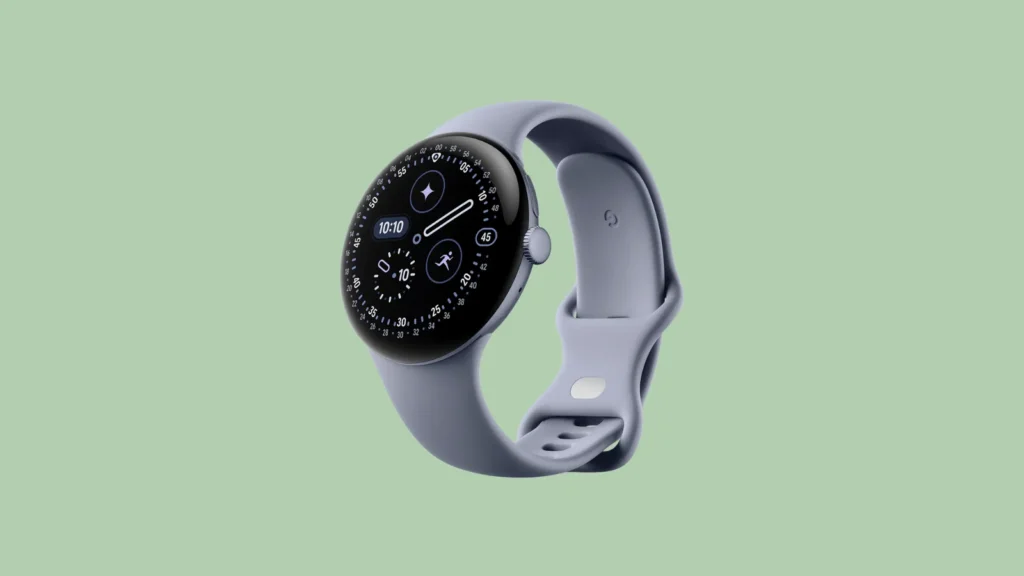 Front view of a round black smartwatch with grey band on light green background, displaying time and digital widgets.