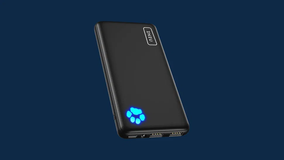 Front view of black power bank with dual USB ports, rectangular button, and blue paw-shaped LED, on dark blue background.