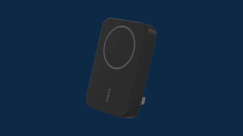 Front view of a black Belkin wireless charging power bank, circular pad, USB-C port on side, on dark blue background.