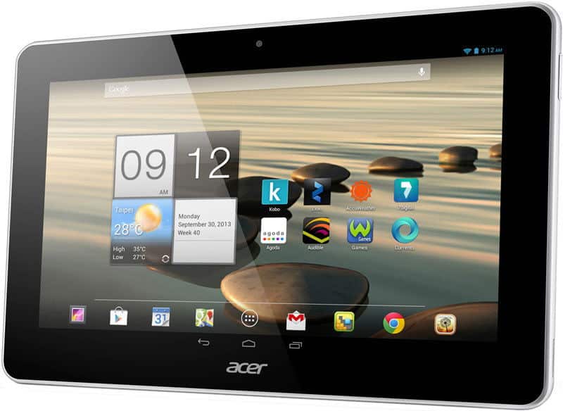 Front view of black Acer tablet showing home screen with app icons, weather widget, and 9:12 AM over a serene water background.