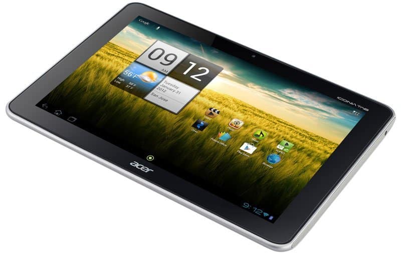 Acer tablet, front angled view, showing home screen with weather, time (9:12), app icons, grassy field and blue sky background.