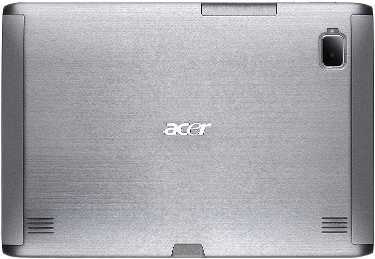 Rear view of a silver Acer tablet showing brushed metal finish, center logo, top-right camera, and bottom speaker grills.
