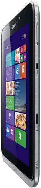 Acer tablet (silver) angled view showing Windows home screen with colorful tiles; edges and side buttons visible.