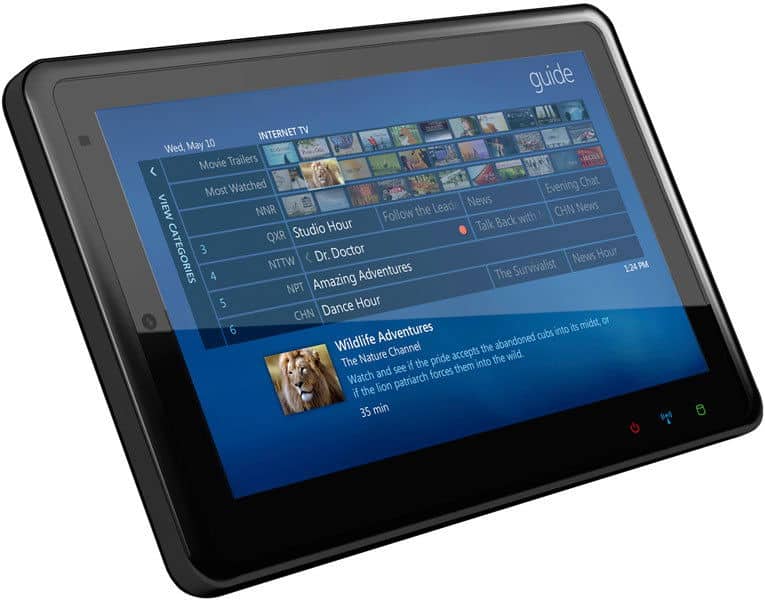 Front view of a black tablet (brand/model unspecified) showing a digital TV guide; "Wildlife Adventures" is highlighted.