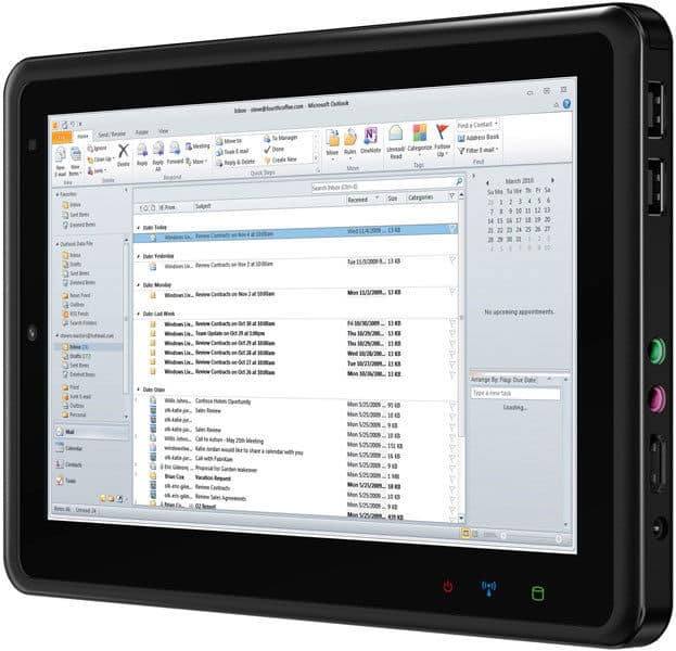 Front view of a black Microsoft Surface tablet showing Outlook inbox; side ports and buttons are visible.