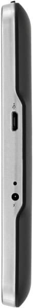 Close-up side view of a silver and black tablet with USB port, small button, and circular opening. Brand/model not specified.