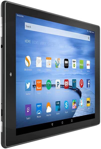 Amazon Fire tablet, front view showing home screen with Netflix, Hulu, Twitter apps over a dock and water background.