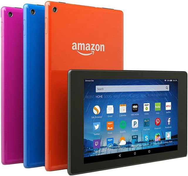 Front view of four Amazon Fire tablets in pink, blue, and orange, one foreground tablet showing its app-filled home screen.
