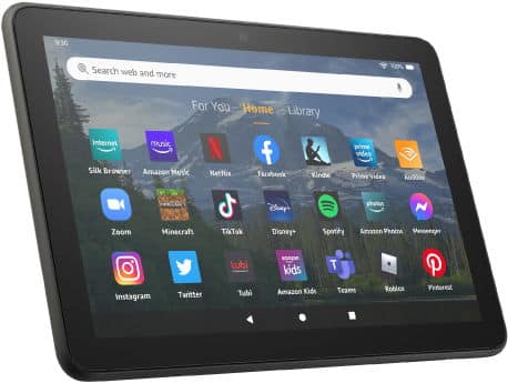 Front view of a black Amazon Fire tablet displaying home screen with popular app icons and a mountain landscape wallpaper.