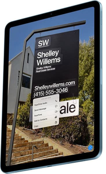 IPad front view showing a real estate sign and contact menu with FaceTime Audio and Send Message options over the phone number.