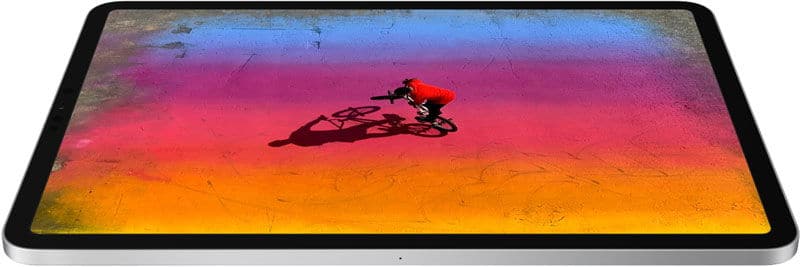 Flat-lay view of a tablet showing an aerial shot of a cyclist on a colorful gradient surface; brand/model not specified.