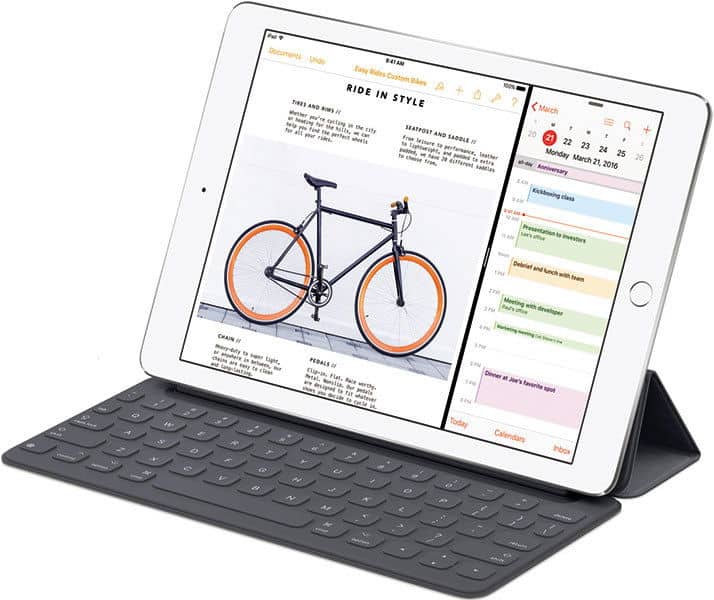 Front view of Apple iPad with black keyboard case, screen showing split view: document on left, calendar on right.