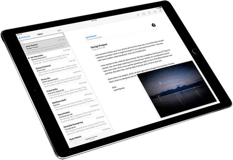 Front view of a tablet running an email app; message list on left, open email with night sky image on right. Brand/model not shown.