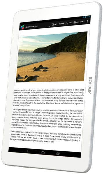 White Archos tablet (angled front view) shows article with beach and cliffs photo, plus multiple paragraphs of text onscreen.