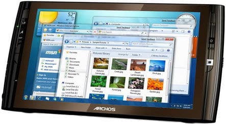 Front view of a black Archos tablet running Windows 7 with open internet, email, and picture library windows visible on screen.