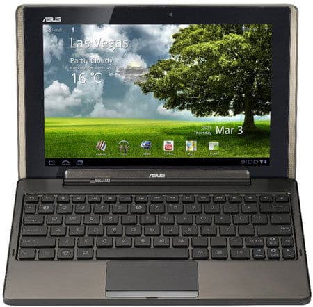 Front view of a black Asus tablet with detachable keyboard, showing Las Vegas weather widget and outdoor scenic background.