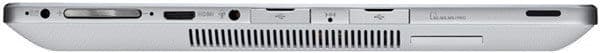 Side view of silver laptop with USB, HDMI, headphone jack, volume control, ventilation grille, and memory card slot visible.