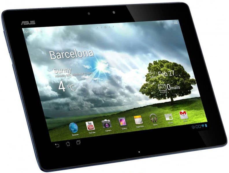 Front view of black ASUS tablet showing Barcelona weather app, 4°C, sunny, with apps and a tree in a green field background.