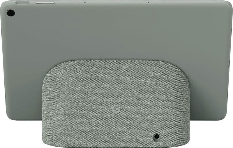 Rear view of a gray tablet on a matching fabric charging stand with circular logo and camera cutout in lower right corner.
