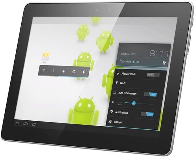 Front view of a black tablet running Android OS, showing settings menu and green Android mascots in the background.