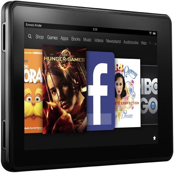 Front view of a black tablet showing a home screen carousel with app icons, media, and top menu tabs for Shop, Games, Apps, Books, Music.