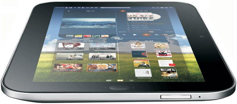 Front view of a tablet on a flat surface displaying a music library with album covers, song lists, and playback controls.