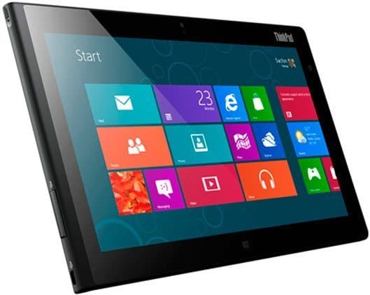 Microsoft Surface tablet angled to show side buttons and thickness, displaying colorful Windows 8 Start screen app tiles.