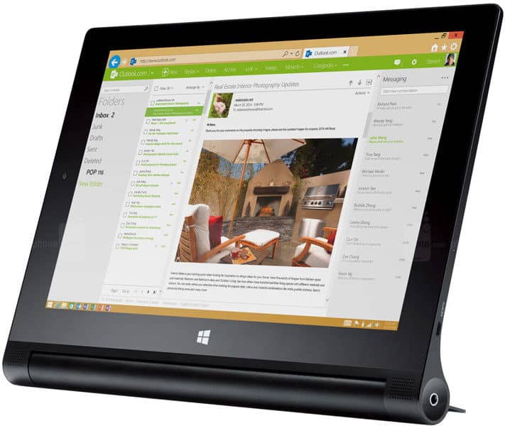 Angled view of a black Microsoft Surface tablet showing Outlook inbox and open email with patio photo, thick bottom bezel visible.