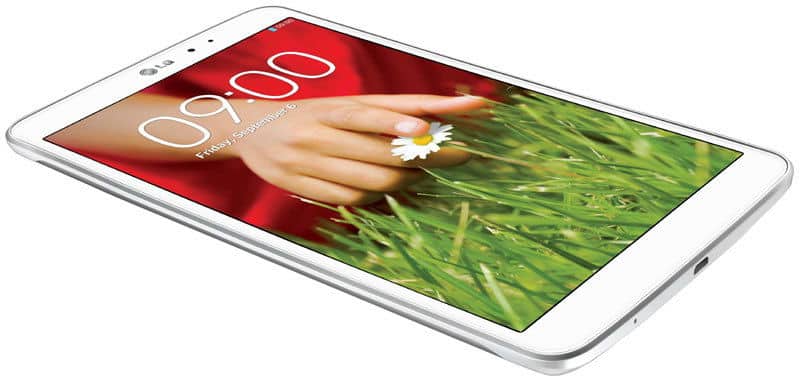 Front angled view of a white LG tablet showing display with hand holding daisy, grass background, 09:00, Friday, September 6.