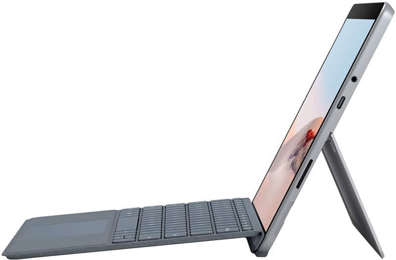 Side view of a slim gray tablet with detachable keyboard and kickstand, set up like a laptop with the screen tilted back.