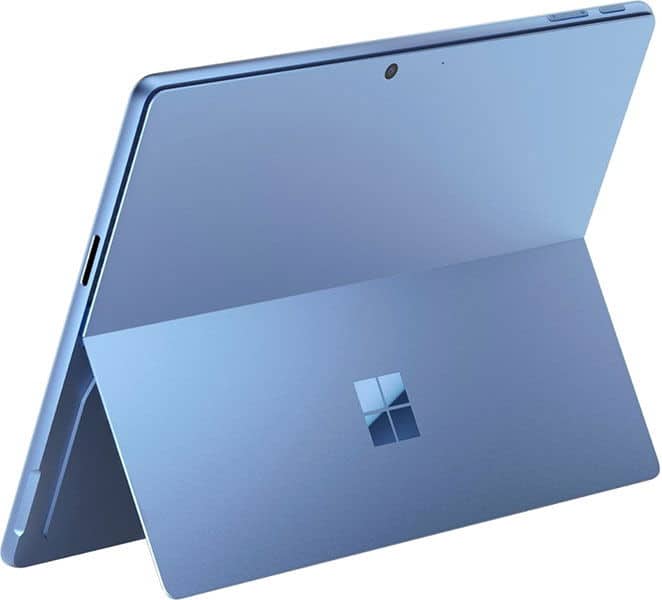 Rear view of blue Microsoft Surface tablet with kickstand extended, Windows logo on kickstand, and camera at top center.