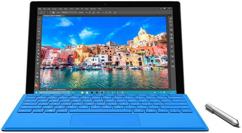 Front view of a tablet with a blue keyboard showing an edited photo; stylus rests beside the device on the surface.