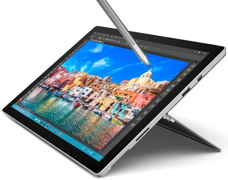 Front view of tablet with kickstand in use; stylus editing vibrant waterfront scene on screen in image editing app.