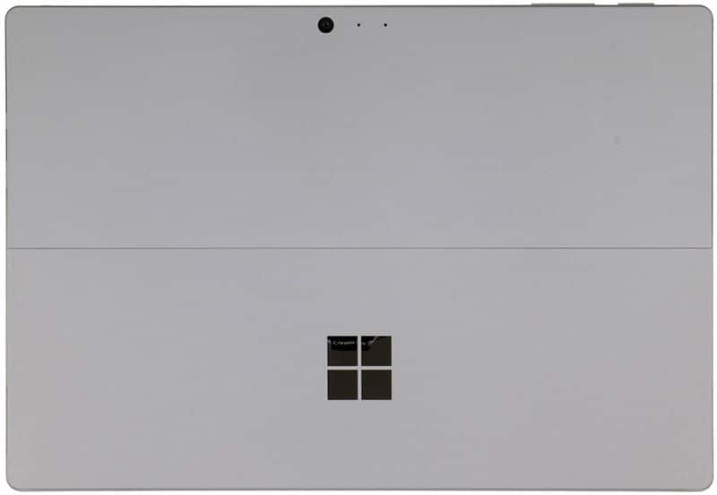 Rear view of silver Microsoft Surface tablet, showing kickstand, centered logo, top-edge camera, and sensors.