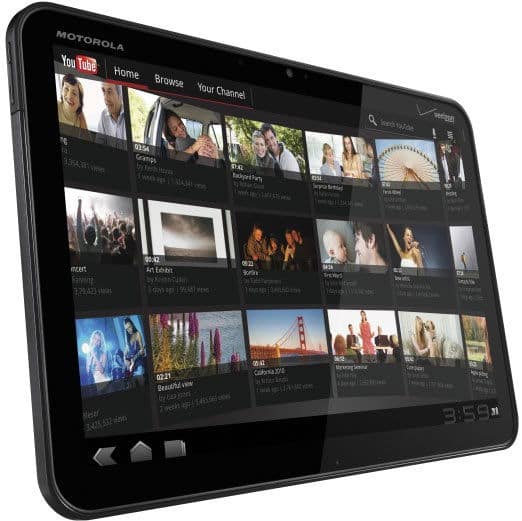 Front view of Motorola tablet showing YouTube interface with video thumbnails, titles, views, and time 3:59 in corner.