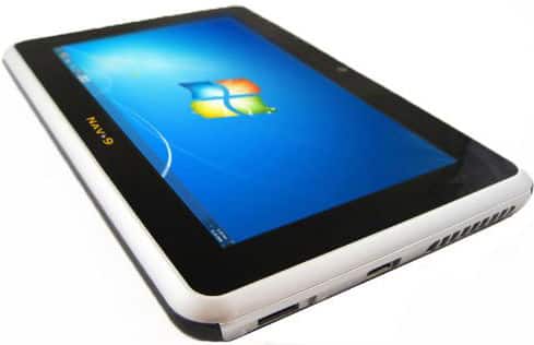 Front view of tablet showing Windows 7 home screen, black front, silver edges, side ports, "MAY 9" label on edge.