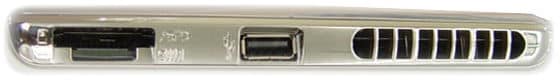 Side view close-up of a laptop highlighting ventilation grilles, a USB port, and a memory card slot.