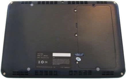 Rear view of closed laptop underside, showing vents, access panel, rubber feet, and product info label.