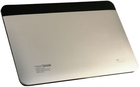 Nextbook tablet rear view, silver with black top strip; logo and model info in lower left on white background.