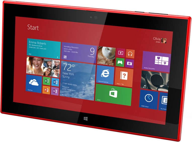 Front view of a red Microsoft Surface RT showing Windows 8 Start screen app tiles, on a white background.