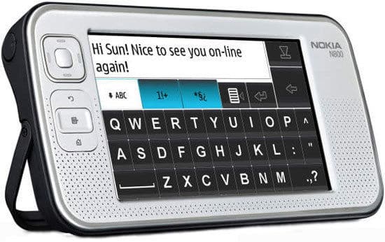 Front view of Nokia 810 internet tablet showing on-screen keyboard, message, left-side buttons, and rear stand visible.