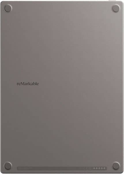 Rear view of reMarkable tablet showing metallic gray back, four corner rubber feet, and "reMarkable" logo at center.