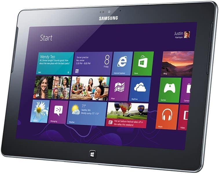 Front view of Microsoft Surface tablet showing Windows 8 Start screen with colorful app tiles, including Weather and Mail.