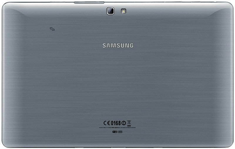 Rear view of a silver Samsung tablet, logo centered, rear camera and flash top left, brushed metal finish, certification at bottom.
