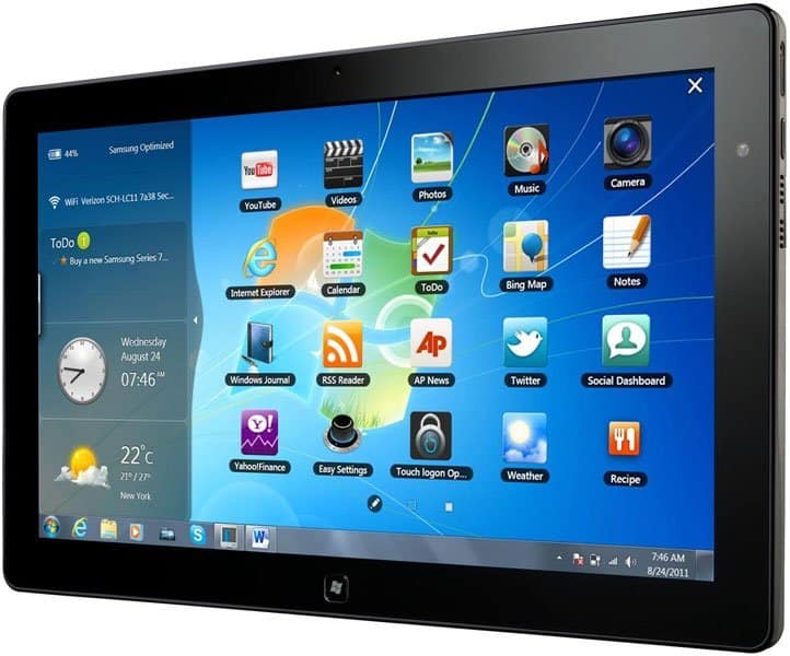Front view of a black Windows tablet showing the Windows 7 desktop with app icons and a weather widget on the left side.